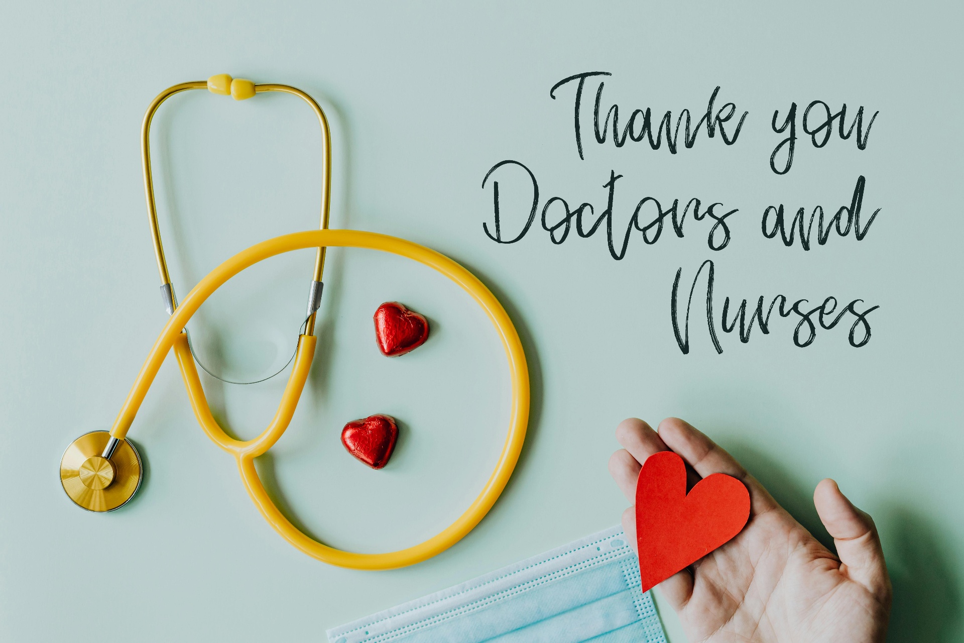 Thank you message for doctors and nurses with golden stethoscope, red hearts, and medical mask on mint background
